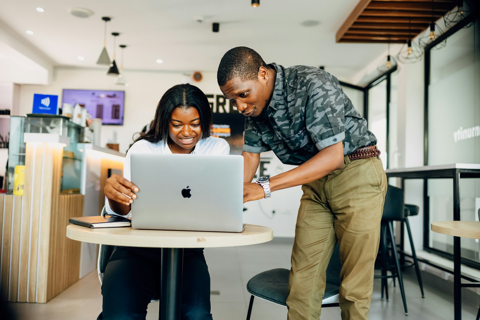 A man and a woman looking at a laptop